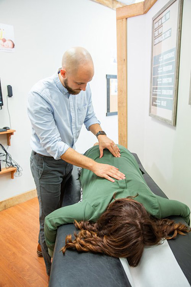 Chiropractor Frederick MD Adam Smith Back Adjusting Pregnant Woman