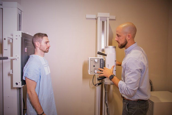 Chiropractor Frederick MD Adam Smith Talking To Patient X-Ray