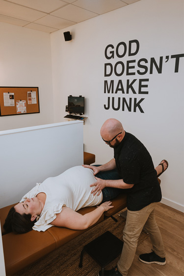 Chiropractor Frederick MD Jared Holt Adjusting Pregnant Patient