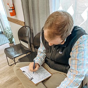 Chiropractic Frederick MD Patient Filling Out Paperwork Chiropractic Frederick MD Patient Filling Out Paperwork